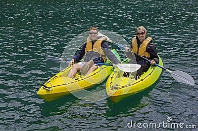 Couple Kayaking on a lake together Stock Photo