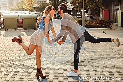Couple kissing funny on the sidewalk Stock Photo