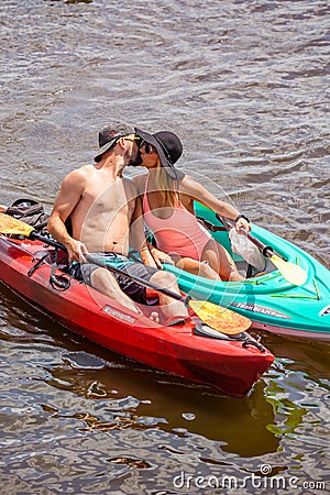 Couple kissing in kayaks at the 4th Annual Paddle Pub Crawl 7/28/18 Editorial Stock Photo
