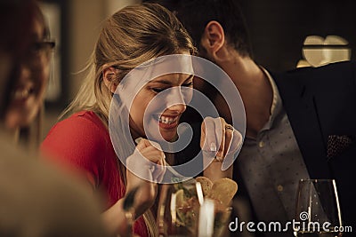 Couple Kissing In Restaurant Stock Photo