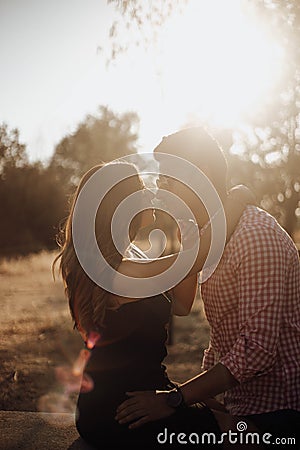 Couple kissing at sunset in summer Stock Photo