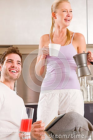 Couple in kitchen having breakfast Stock Photo