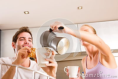 Couple in kitchen having breakfast Stock Photo