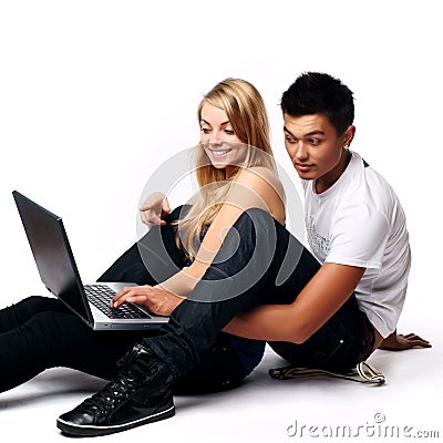 Couple with laptop, sitting on floor Stock Photo