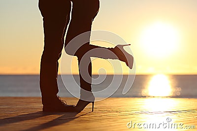 Couple legs hugging in love on the beach Stock Photo