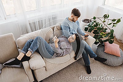 Couple in living room obsessed with smartphones Stock Photo
