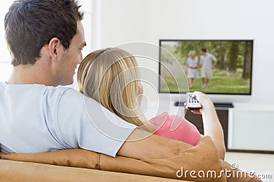 Couple in living room watching television Stock Photo