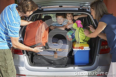 Couple Loading Luggage Into Car Trunk Stock Photo