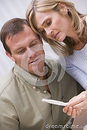 Couple looking at home pregnancy test Stock Photo