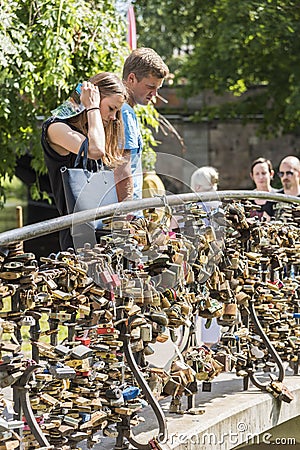 Couple looking at love locks Riga Editorial Stock Photo