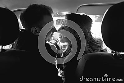 Couple looking to each other in the car Stock Photo