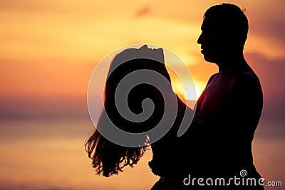 Couple in love back light silhouette on sea Stock Photo