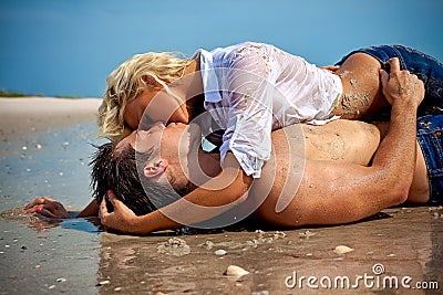 Couple in love at the beach kissing Stock Photo