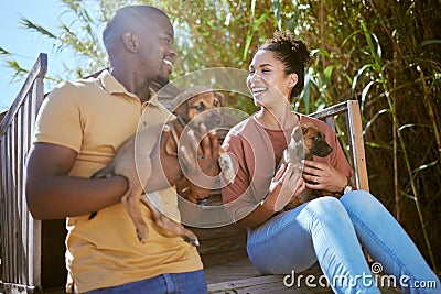 Couple, love and bonding with puppy dogs in animal shelter, adoption center of volunteer community charity for canines Stock Photo