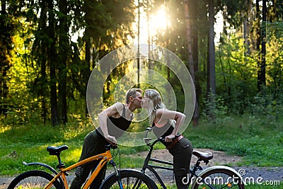 Couple in love kissing on bicycles Stock Photo