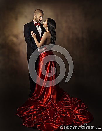 Couple in Love, Lovers Woman and Man, Glamour Classic Suit and Dress with Long Tail, Fashion Beauty Portrait of Young Models Stock Photo