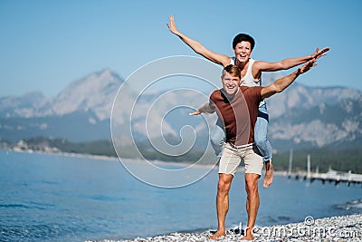 Couple in love opened their arms like the wings of an airplane. Trave concerts. Stock Photo