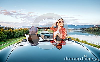 Couple in love ride in cabriolet on the picturesque mountain road Stock Photo
