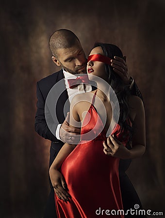 Couple in Love, Fashion Woman and Man, Girl with Red Band on Eyes Charming Boyfriend in Suit, Glamor Model Portrait Stock Photo