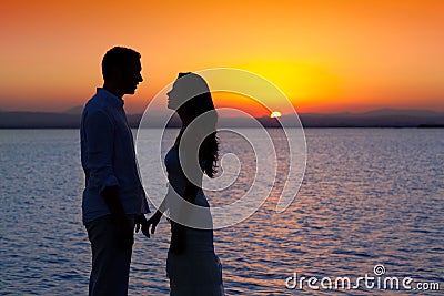 Couple in love silhouette at lake sunset Stock Photo