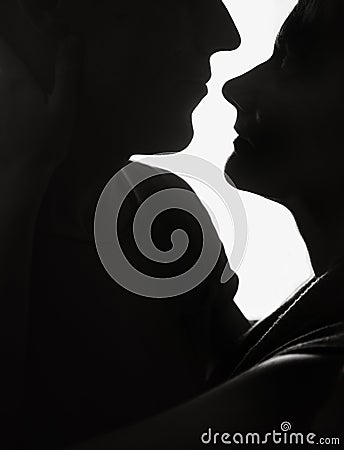 Couple in love silhouette looking white light Stock Photo
