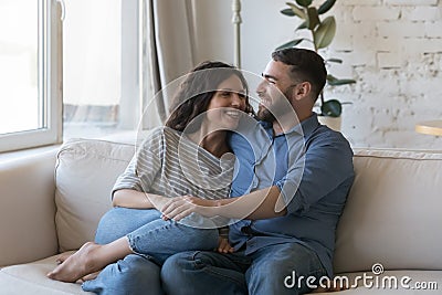 Couple in love sit on sofa enjoy weekend at home Stock Photo