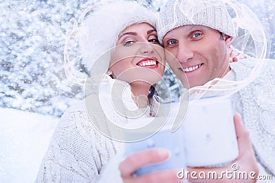 Couple in love in snow forest with heart frame from steam Stock Photo