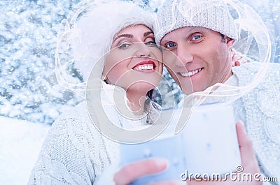 Couple in love in snow forest with heart frame from steam Stock Photo