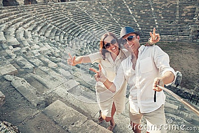 Couple in love take a selfie photo in ancient amphitheater in th Stock Photo