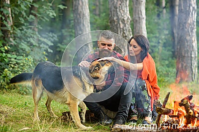 Couple in love, young happy family spend leisure with dog. Stock Photo