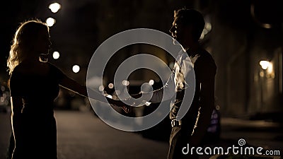 Couple of lovers dancing in empty night street, dating and love, seduction Stock Photo