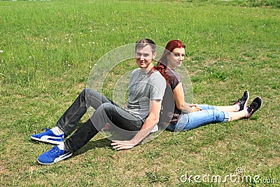 Couple of lovers sitting on meadow Stock Photo