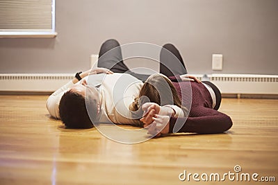 Couple lying on empty floor Stock Photo