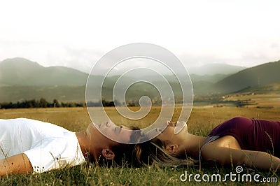 Couple lying on the grass Stock Photo