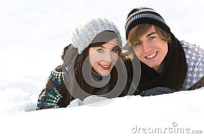 Couple lying in snow Stock Photo