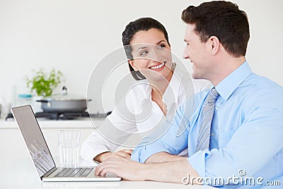 Couple Making Online Purchase At Home Stock Photo