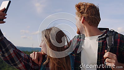 Couple making video on smartphone in mountains. Hikers having video chat Stock Photo