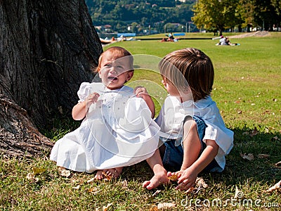 Couple of male and female children in green meadow portrait Stock Photo