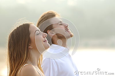 Couple of man and woman breathing deep fresh air Stock Photo