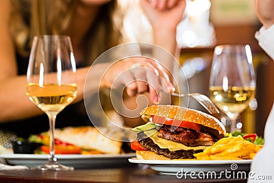 Happy couple in restaurant eat fast food Stock Photo