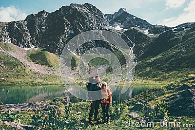 Couple Man and Woman hiking together at mountains Love and Travel Lifestyle Stock Photo