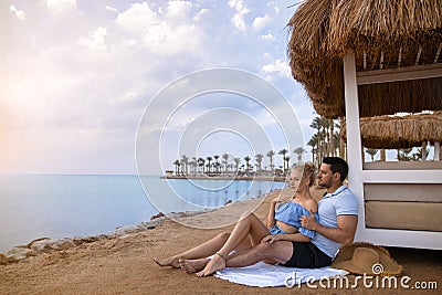 Couple man and woman on the ocean seashore - romantic hugs Stock Photo