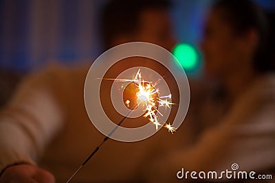 Couple in matching close holding bengal lights Stock Photo