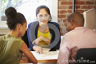 Couple Meeting With Financial Advisor In Office Stock Photo
