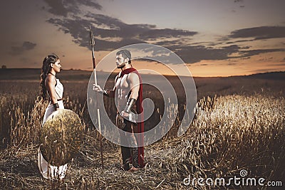 Couple meeting after war in field at night time. Stock Photo