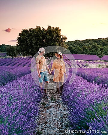 Couple mid age men and woman on vacation in the Provence visiting the blooming lavender fields in France Stock Photo