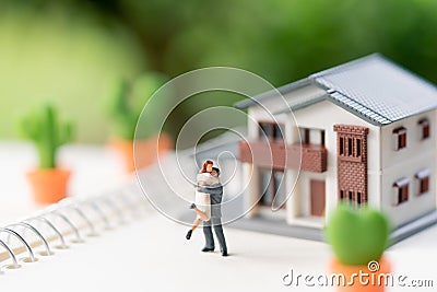 Couple Miniature 2 people standing model with house model make f Stock Photo