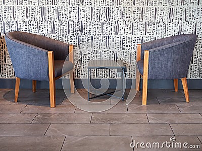 Couple modern blue fabric wooden armchair with table in the middle Stock Photo