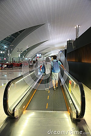 Couple moving at escalator Indore Dubai international Airport Editorial Stock Photo