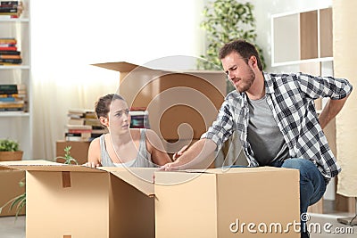 Couple moving home and man having an accident Stock Photo